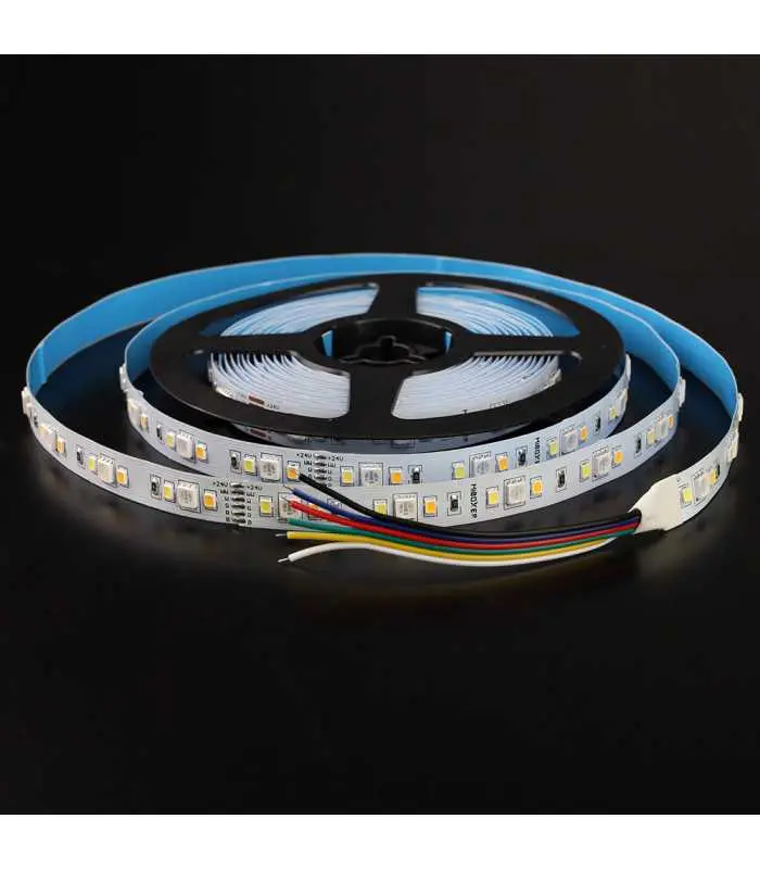 RGB LED strip light on a black background: A coiled RGB LED strip light on a black surface, showing colour-coded wires attached