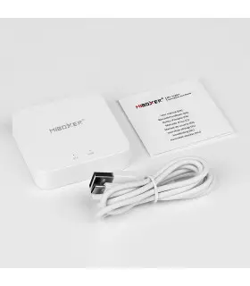 MiBoxer 2.4GHz Gateway with cable: Gateway device next to a white cable and instruction manual on a white surface.