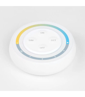 A close-up view of a round white remote control with a colourful circular ring, designed for controlling lighting zones