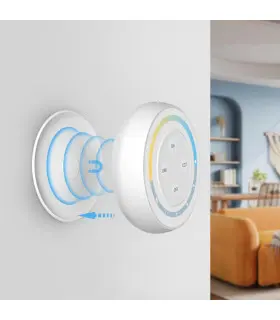 A wall-mounted circular remote with glowing LED indicators, demonstrating its functionality in a well-furnished living room