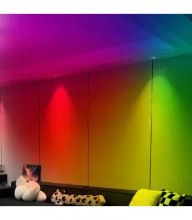 MiBoxer 6W RGB+CCT LED downlight illuminating a living room with colourful, gradient lighting effects.