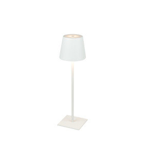 White table lamp illuminated, demonstrating its warm light and modern aesthetic on a simple square base.