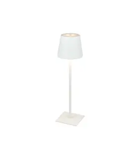 White table lamp illuminated, demonstrating its warm light and modern aesthetic on a simple square base.