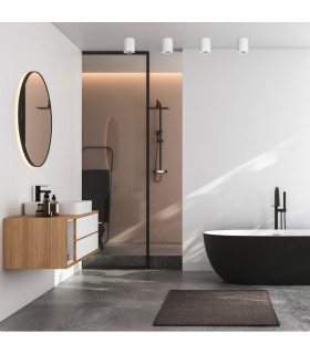 Stylish bathroom interior with black accents, featuring white surface-mounted downlights and a freestanding bathtub.