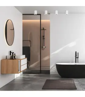 Stylish bathroom interior with black accents, featuring white surface-mounted downlights and a freestanding bathtub.