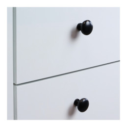 Matte black round knobs on white drawer fronts