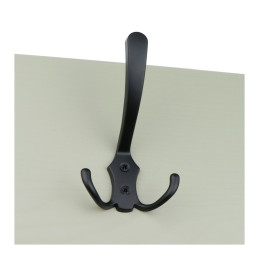 Black metal coat hook mounted on a beige surface.