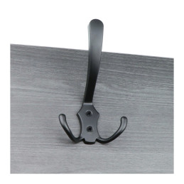 Black metal coat hook mounted on a grey wooden surface.