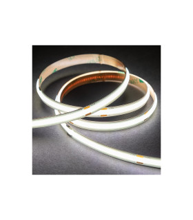 Rolled-up COB LED strip emitting bright white light on a dark surface.