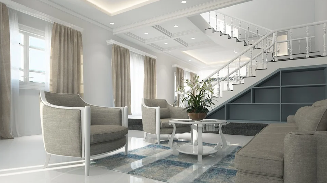 Living room with recessed ceiling lights: Elegant living room with recessed LED lights, grey seating, staircase, and natural light.